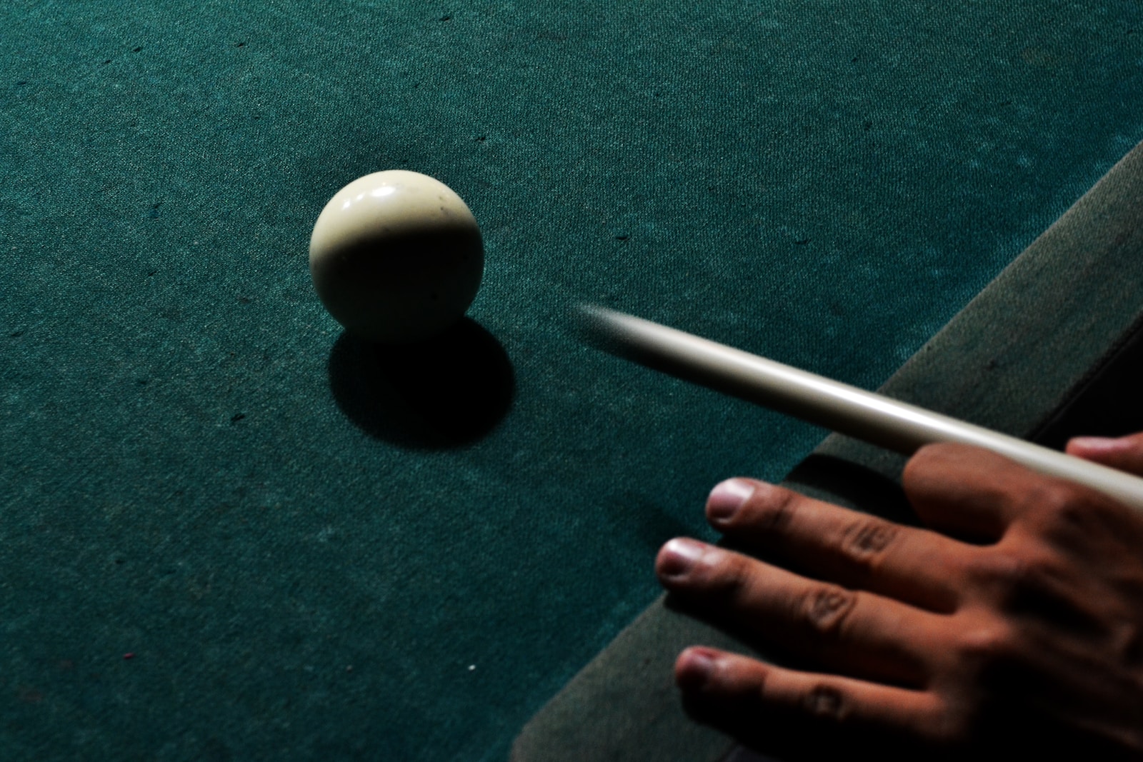 Learning How to Play Billiards 8 person holding brown cue stick